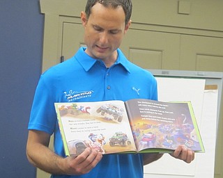 Neighbors | Zack Shively.Drag racer Ryan Martino read a book to the children during the Science Stories with Ryan Martino on Sept. 18 at the Boardman library. Martino expressed the importance of the library and literacy.