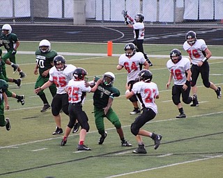 Neighbors | Submitted .Canfield Village Middle School quarterback Broc Lowry looked downfield for a receiver.
