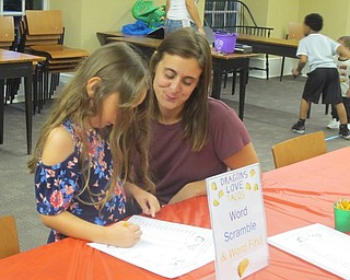 Neighbors | Zack Shively.A parent and child worked on a word scramble worksheet relating to different elements of Adam Rubin's "Dragons Love Tacos" books.