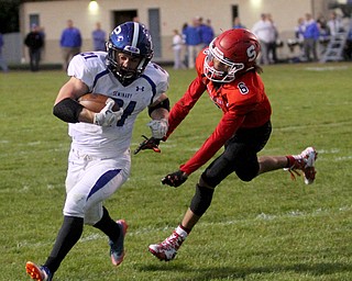 Poland running back Dante Romano(21) runs the ball away from Struthers defensive back Adrian Brown(6) for a touchdown during the first quarter as Poland High School takes on Struthers High School, Friday, Sept. 29, 2017, at Stuthers High School in Struthers. Poland won 33-0...(Nikos Frazier | The Vindicator)..
