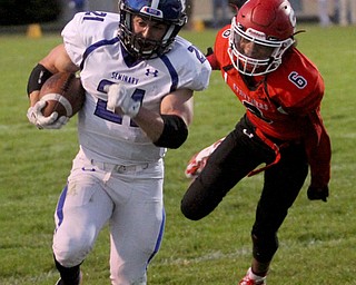 Poland running back Dante Romano(21) runs the ball away from Struthers defensive back Adrian Brown(6) for a touchdown during the first quarter as Poland High School takes on Struthers High School, Friday, Sept. 29, 2017, at Stuthers High School in Struthers. Poland won 33-0...(Nikos Frazier | The Vindicator)..