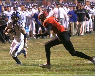 Poland running back Dante Romano(21) runs the ball away from Struthers defensive back Tyrese Hawkins(5) for a touchdown during the first quarter as Poland High School takes on Struthers High School, Friday, Sept. 29, 2017, at Stuthers High School in Struthers. Poland won 33-0...(Nikos Frazier | The Vindicator)..
