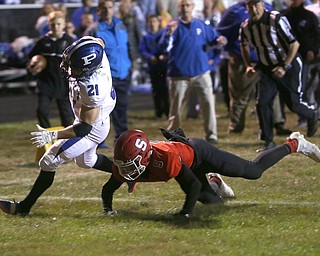 Poland running back Dante Romano(21) runs the ball away from Struthers defensive back Tyrese Hawkins(5) for a touchdown during the first quarter as Poland High School takes on Struthers High School, Friday, Sept. 29, 2017, at Stuthers High School in Struthers. Poland won 33-0...(Nikos Frazier | The Vindicator)..