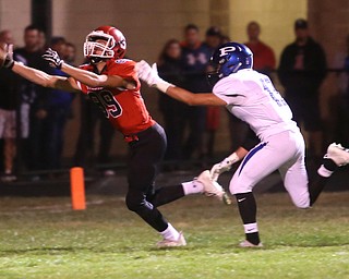 Struthers wide receiver Kevin Caldwell(89) and Poland defensive back Brandon Barringer(13) run for the long pass during the second quarter as Poland High School takes on Struthers High School, Friday, Sept. 29, 2017, at Stuthers High School in Struthers. Poland won 33-0...(Nikos Frazier | The Vindicator)..