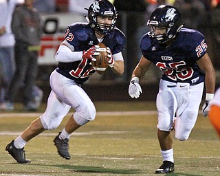 William D. Lewis The Vindicator Fitch QB Joey Zielinski(12) sdrambles as Randy Smith(25) cuts downfield during 9-29-17 action at Fitch.