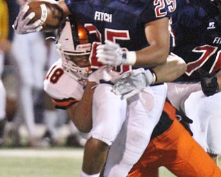 William D. Lewis The Vindicator Fitch's Randy Smith (25) is stopped by Massillon's Kameron Simpson(18)during 1rst half action 9-29-17 at Fitch.