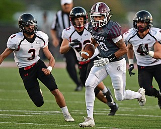 Boardman's Maurice Pickard runs the ball for a big gain away from Canfield's Anthony D'Alesio, David Crawford and Dominik Gelonese during the first half of their game Friday night at Boardman High School. Canfield won 17-7. DAVID DERMER | THE VINDICATOR