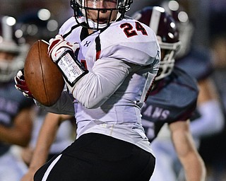 Canfield's Angelo Petracci turns upfield to run after a reception in the middle of the field during the first half of their game Friday night at Boardman High School. Canfield won 17-7. DAVID DERMER | THE VINDICATOR