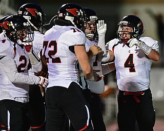 Canfield's Paul Breinz, right, celebrats with his teammates including Mike Dudash, Angelo Petracci and others after scoring a touchdown during the first half of their game Friday night at Boardman High School. Canfield won 17-7. DAVID DERMER | THE VINDICATOR