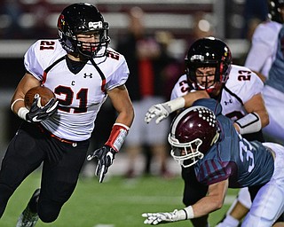 Canfield's Nick Crawford, left, runs the football around the outside after picking up a block from David Crawford on Boardman's Connor Miller during the first half of their game Friday night at Boardman High School. Canfield won 17-7. DAVID DERMER | THE VINDICATOR