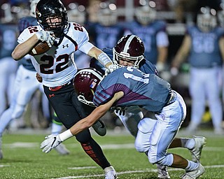 Canfield's Tyler Dobrindt is tackled by Boardman's Mike Fetsko and Boardman's Neil Bevaqua during the first half of their game Friday night at Boardman High School. Canfield won 17-7. DAVID DERMER | THE VINDICATOR