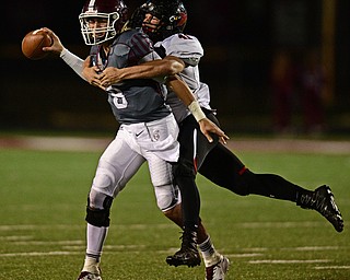 Boardman's Mike O'Horo, left, is sacked by Canfield's Anthony D'Alesio during the second half of their game Friday night at Boardman High School. Canfield won 17-7. DAVID DERMER | THE VINDICATOR