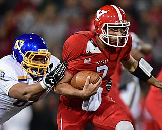 Youngstown State quarterback Nathan Mays(7) runs the ball while being grabbed by South Dakota State defensive tackle Xavier Ward(67) during the first half of their game Saturday, Sept. 30, 2017, at Stambuagh Stadium in Youngstown, Ohio. ..(David Dermer | The Vindicator)..