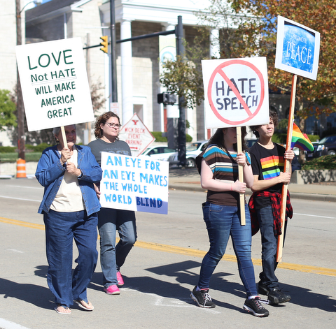 A group holds picket signs during the seventh annual Nonviolence Parade and Rally, Oct. 1, 2017, in downtown Youngstown...(Nikos Frazier | The Vindicator)