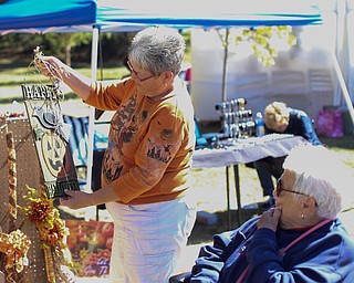 Carol McRoberts(left) of East Palestine shows a Halloween sign to her mom, Shirley Gorby during the Boardman Rotary's annual Oktoberfest, Oct. 1, 2017, at Boardman Park in Boardman...(Nikos Frazier | The Vindicator)