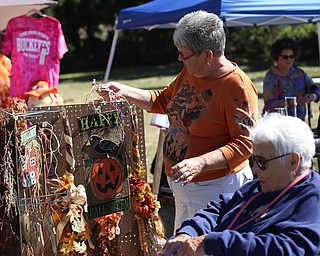 Carol McRoberts(left) of East Palestine shows a Halloween sign to her mom, Shirley Gorby during the Boardman Rotary's annual Oktoberfest, Oct. 1, 2017, at Boardman Park in Boardman...(Nikos Frazier | The Vindicator)