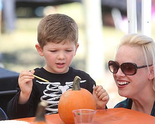Kristen Democko of Hubbard smiles as her son, Draven(4) paints a pumpkin during the Boardman Rotary's annual Oktoberfest, Oct. 1, 2017, at Boardman Park in Boardman...(Nikos Frazier | The Vindicator)