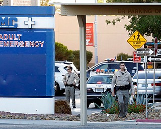 Las Vegas police work on the scene of an officer-involved shooting at University Medical Center on Monday, Sept. 25, 2017, in Las Vegas. Authorities say a man shot dead by a patrol officer was in police custody and under observation for intoxication when he obtained a stun gun and pointed it at a security guard and nurse. (Bizuayehu Tesfaye/Las Vegas Review-Journal via AP)