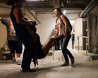 People assist a wounded woman at the Tropicana during an active shooter situation on the Las Vegas Stirp in Las Vegas Sunday, Oct. 1, 2017. Multiple victims were being transported to hospitals after a shooting late Sunday at a music festival on the Las Vegas Strip. (Chase Stevens/Las Vegas Review-Journal via AP)