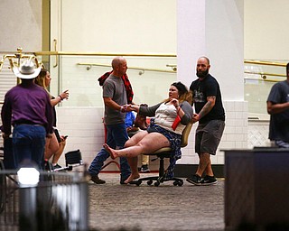 A wounded woman is moved outside the Tropicana during an active shooter situation on the Las Vegas Strip in Las Vegas Sunday, Oct. 1, 2017. Multiple victims were being transported to hospitals after a shooting late Sunday at a music festival on the Las Vegas Strip. (Chase Stevens/Las Vegas Review-Journal via AP)