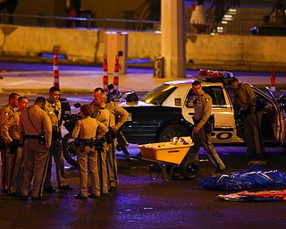 Las Vegas police gather following a deadly shooter at a music festival Monday, Oct. 2, 2017, in Las Vegas. (Chase Stevens/Las Vegas Review-Journal via AP)