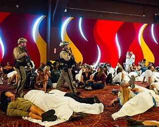 Las Vegas police sweep through a convention center area during a lockdown Monday, Oct. 2, 2017, at the Tropicana Las Vegas following an active shooter situation on the Las Vegas Strip. Multiple victims were transported to hospitals after a deadly shooting late Sunday at a music festival on the Las Vegas Strip. (Chase Stevens/Las Vegas Review-Journal via AP)