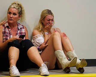 A woman cries while hiding inside the Sands Corporation plane hangar after a mass shooting in which dozens were killed at the Route 91 Harvest Festival on Sunday, Oct. 1, 2017, in Las Vegas. (Al Powers/Invision/AP)
