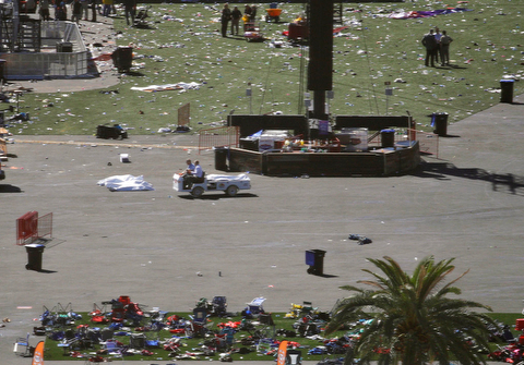 People drive a cart through the scene of a mass shooting at a music festival on the Las Vegas Strip, Monday, Oct. 2, 2017, in Las Vegas. (AP Photo/John Locher)