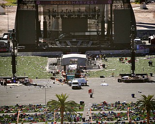 Debris is strewn through the scene of a mass shooting at a music festival near the Mandalay Bay resort and casino on the Las Vegas Strip, Monday, Oct. 2, 2017, in Las Vegas. (AP Photo/John Locher)