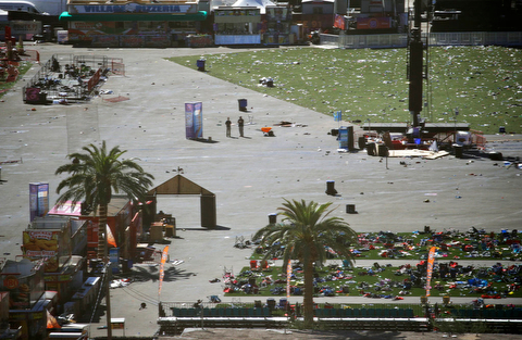 EDS NOTE: GRAPHIC CONTENT - Debris is strewn through the scene of a mass shooting at a music festival near the Mandalay Bay resort and casino on the Las Vegas Strip, Monday, Oct. 2, 2017, in Las Vegas. (AP Photo/John Locher)