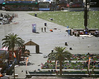 EDS NOTE: GRAPHIC CONTENT - Debris is strewn through the scene of a mass shooting at a music festival near the Mandalay Bay resort and casino on the Las Vegas Strip, Monday, Oct. 2, 2017, in Las Vegas. (AP Photo/John Locher)