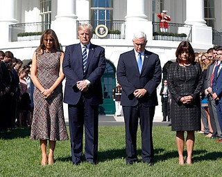 President Donald Trump and first lady Melania Trump stand with vice president Mike Pence and his wife Karen during a moment of silence to remember the victims of the mass shooting in Las Vegas, on the South Lawn of the White House in Washington, Monday, Oct. 2, 2017. (AP Photo/Pablo Martinez Monsivais)