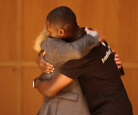 William D. Lewis The Vindicator  2017 Simeon Booker Award for Courage recipients Terry Vicars, left, and Ken Nwadike Jr. hug during 10-3 event at DeYor Performing Arts Center in Youngstown.
