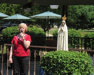 Neighbors | Zack Shively.Judy Studer, custodian of the Our Lady of Fatima statue, told her story of her rekindled faith to those at Beeghly Oaks on Aug. 14 for the Our Lady of Fatima mass and communion.