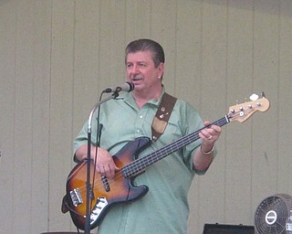 Neighbors | Zack Shively  .Alan Koss, bassist for the Del Sinchak Band, sang the ballad "Waltz of the Angels" on Aug. 17 in Boardman Park as a part of the Music in the Park concert series.
