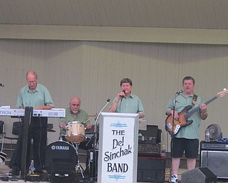 Neighbors | Zack Shively  .The Del Sinchak Band performed on the Maag Outdoor Theater stage at Boardman Park on Aug. 17. The band played despite numerous weather reports calling for thunderstorms. Pictured, from left, are Ron Austalosh,  Bob Smrecansky , Del Sinchak and Alan Koss.
