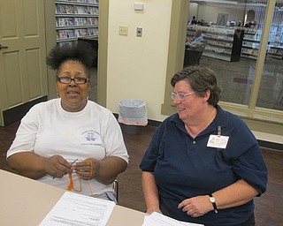 Neighbors | Zack Shively  .Pictured, from left, Carol Bell and Karen Saunders during the All About Yarn event on Aug. 18. Saunders helped Bell remember and better some crochet techniques. The event is held monthly in Boardman library.