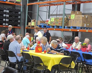 Neighbors | Zack Shively  .Volunteers of the Second Harvest Food Bank enjoy their food and drinks provided at Volunteer Appreciation Day on Aug. 26. "Our volunteers are our heroes," said Michael Iberis said of them.