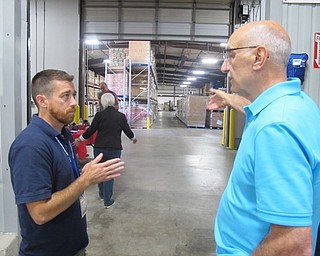 Neighbors | Zack Shively  .Executive director Michael Iberis giving instructions to help make the Volunteer Day move smoother.