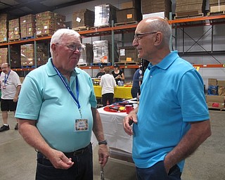 Neighbors | Zack Shively  .Second Harvest Food Bank's executive director Michael Iberis chats with a volunteer during the Volunteer Appreciation Day on Aug. 26. These volunteers help the food bank fill nearly 15,000 requests for food weekly.