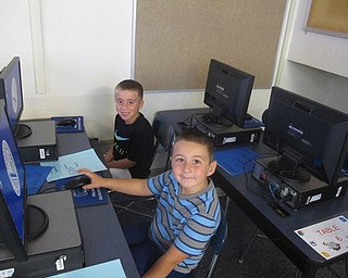 Neighbors | Zack Shively.Two Poland Union Elementary students enjoy their first day in Nick Blanche's technology class on Aug. 28.
