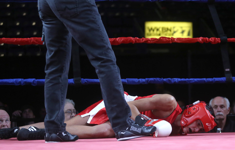 Antimo Lombardi(red) lays on the ground after taking a hard punch to the head by Kaleb Waggoner(black), Thursday, Oct. 5, 2017, at the Covelli Centre in Youngstown. Waggoner won by official ruling ...(Nikos Frazier | The Vindicator)..