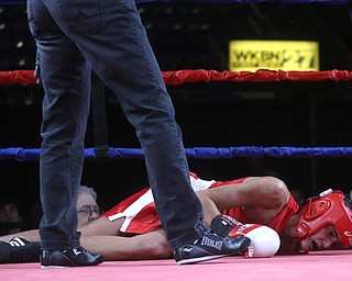 Antimo Lombardi(red) lays on the ground after taking a hard punch to the head by Kaleb Waggoner(black), Thursday, Oct. 5, 2017, at the Covelli Centre in Youngstown. Waggoner won by official ruling ...(Nikos Frazier | The Vindicator)..