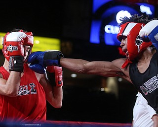 Steve Cunningham Jr.(black) lands a punch on Andrea Piccolo(red), Thursday, Oct. 5, 2017, at the Covelli Centre in Youngstown. Cunningham won after three rounds by points...(Nikos Frazier | The Vindicator)..