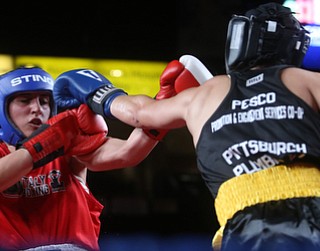 Mary Casamassa(black) connects with Francesca Buonanno(red), Thursday, Oct. 5, 2017, at the Covelli Centre in Youngstown. Casamassa won after three rounds by points...(Nikos Frazier | The Vindicator)..