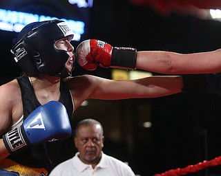 Francesca Buonanno(red) connects with Mary Casamassa(black), Thursday, Oct. 5, 2017, at the Covelli Centre in Youngstown. Casamassa won after three rounds by points...(Nikos Frazier | The Vindicator)..