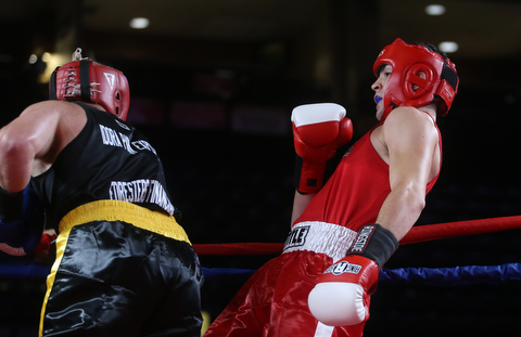 Daniele Pucciarelli(red) dodges a punch from Paul Palombo(black), Thursday, Oct. 5, 2017, at the Covelli Centre in Youngstown. Palombo won after three rounds by points...(Nikos Frazier | The Vindicator)..