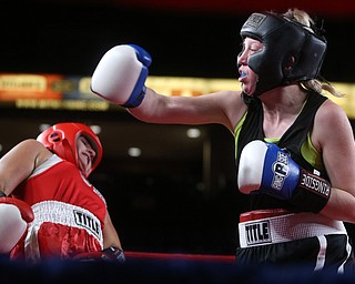 Collen Davis(black) swings slowly at Jessica Palmieri(red), Thursday, Oct. 5, 2017, at the Covelli Centre in Youngstown. Palmieri won after three rounds by points...(Nikos Frazier | The Vindicator)..