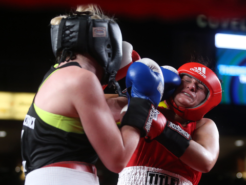 Collen Davis(black) lands a left jab Jessica Palmieri(red), Thursday, Oct. 5, 2017, at the Covelli Centre in Youngstown. Palmieri won after three rounds by points...(Nikos Frazier | The Vindicator)..