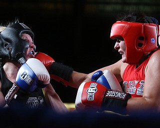 Collen Davis(black) takes one to the head by  Jessica Palmieri(red), Thursday, Oct. 5, 2017, at the Covelli Centre in Youngstown. Palmieri won after three rounds by points...(Nikos Frazier | The Vindicator)..